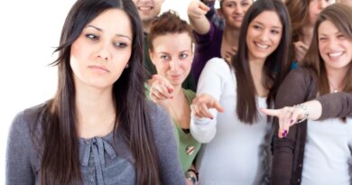 Crowd pointing fingers at a young woman