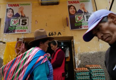 Pedestrians pass campaign signs before the weekend's presidential election in Cuzco, Peru, Wednesday, April 8, 2026. (AP Photo/Martin Mejia)