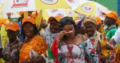 People use umbrellas to shelter from the rain as they wait on a street for Pope Leo XIV to pass by, in Bata, Equatorial Guinea, April 22, 2026. REUTERS/Guglielmo Mangiapane