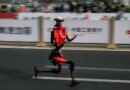The fastest humanoid robot, an H1made by Honor, runs beside human runners at the start on its way to winning the Beijing Humanoid Half Marathon.
