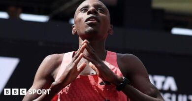 Sabastian Sawe holds up the Adidas supershoe which he wore in breaking the marathon world record in London