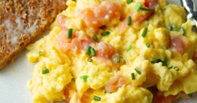 Scrambled eggs with smoked salmon on a plate.