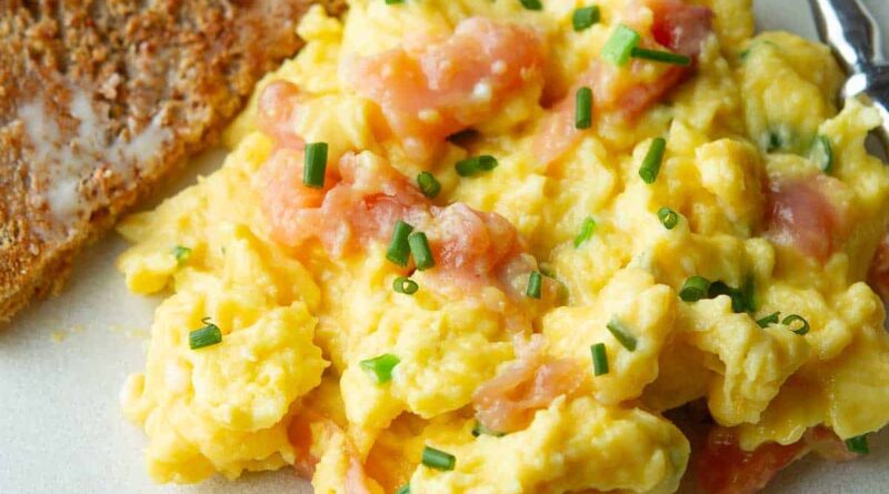 Scrambled eggs with smoked salmon on a plate.