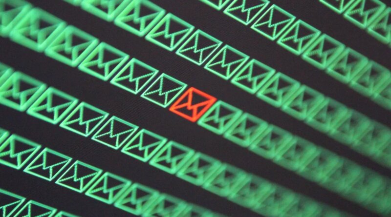 red email envelope in a sea of green email envelopes
