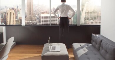 Young man looking out at city skyline.
