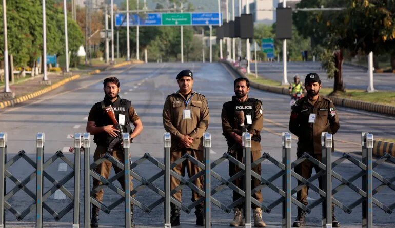 Police officers stand guard behind a barricade near Serena Hotel, as Pakistan prepares to host the U.S. and Iran for the second round of peace talks, in Islamabad, Pakistan, April 25, 2026. REUTERS/Asim Hafeez