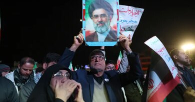An Iranian man holds up picture of Iranian supreme leader Ayatollah Mojataba Khamenei as others react to a ceasefire announcement at the Enqelab square, in Tehran, on April 8 2026.
