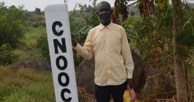 Local farmer Okumu Weke near an EACOP road beacon in Nyamtai village, Kikuube District in the Western Region of Uganda. Credit: Waruru/IPS