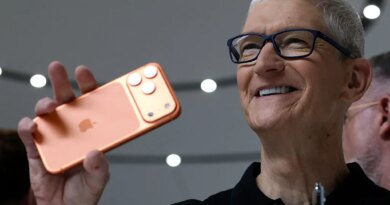 Apple CEO Tim Cook holds up a new iPhone 17 Pro