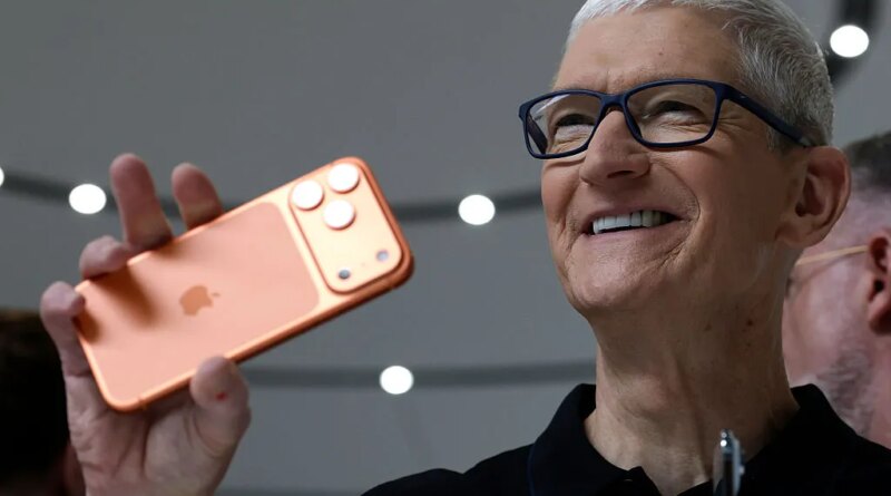Apple CEO Tim Cook holds up a new iPhone 17 Pro