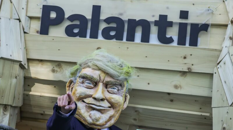 An activist dressed as U.S. President Donald Trump stands in front of a mock Trojan horse