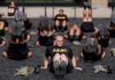 soldiers exrcise in black shirts reading 'ARMY'