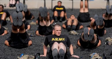 soldiers exrcise in black shirts reading 'ARMY'