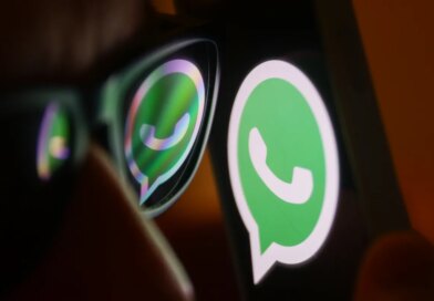 WhatsApp logo reflected on sunglasses and displayed on a phone screen.