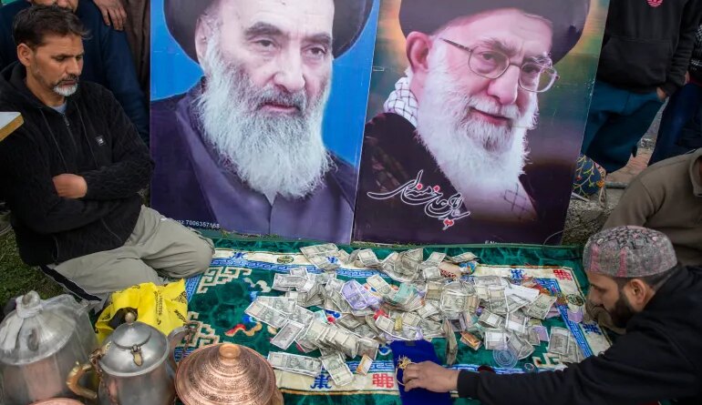 Cash donated for Iran at a collection drive in Indian-administered Kashmir [Junaid Bhat/ Al Jazeera]