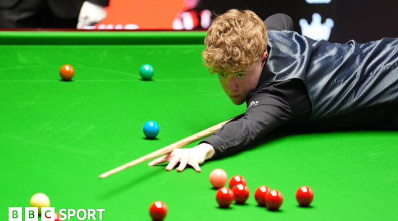Stan Moody stretches over the snooker table to play a shot