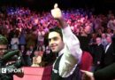 Ronnie O'Sullivan smiles and celebrates with a thumbs-up gesture after winning the 2001 World Championship