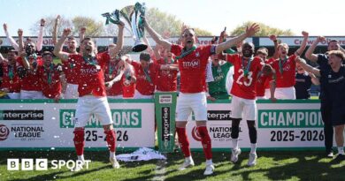 Ollie Pearce and Callum Howe of York City lift the National League Trophy after the 1-1 draw at Rochdale