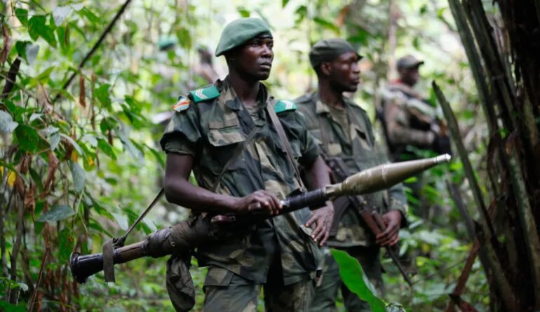 DRC soldiers carrying weapons in a forest whilst patrol against ADF rebels near Beni in North-Kivu province