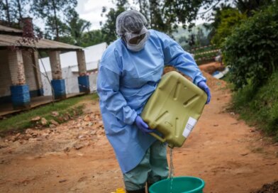 A health worker wearing protective equipment prepares disinfectant materials as she gets ready to disinfect the isolation area for Ebola patients at the General Referral Hospital of Mongbwalu in Mongbwalu [AFP]