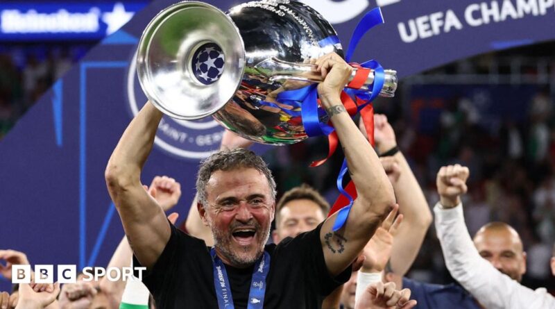Paris St-Germain manager Luis Enrique smiling with the Champions League trophy