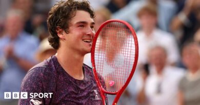Joao Fonseca holds his racquet to his face in celebration