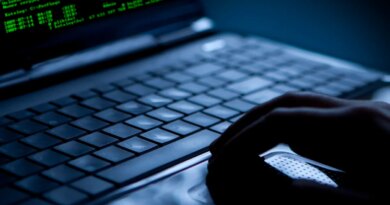 Hacker using laptop. Lots of digits on the computer screen.