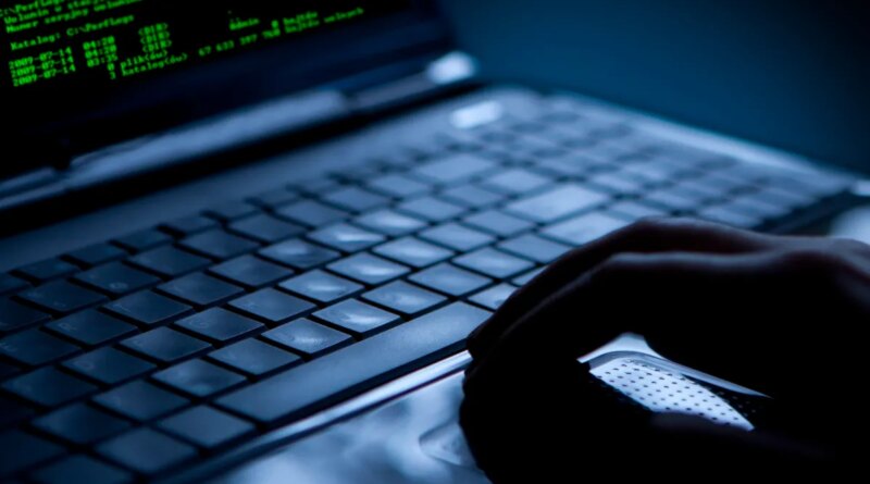 Hacker using laptop. Lots of digits on the computer screen.