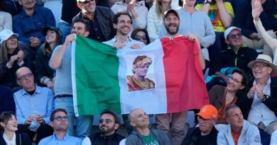 Fans of Jannik Sinner, of Italy, hold an Italian flag with his picture during his final match against Casper Ruud, of Norway, at the Italian Open tennis tournament, in Rome, Sunday, May 17, 2026. (AP Photo/Alessandra Tarantino)