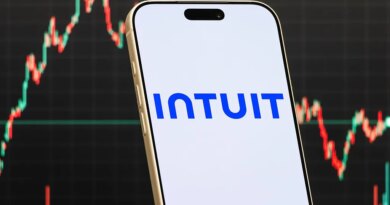 a smartphone displays the logo of Intuit Inc
