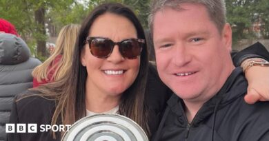 Liverpool Women manager Matt Beard and his wife Debbie smile while celebrating the Reds' Championship title win