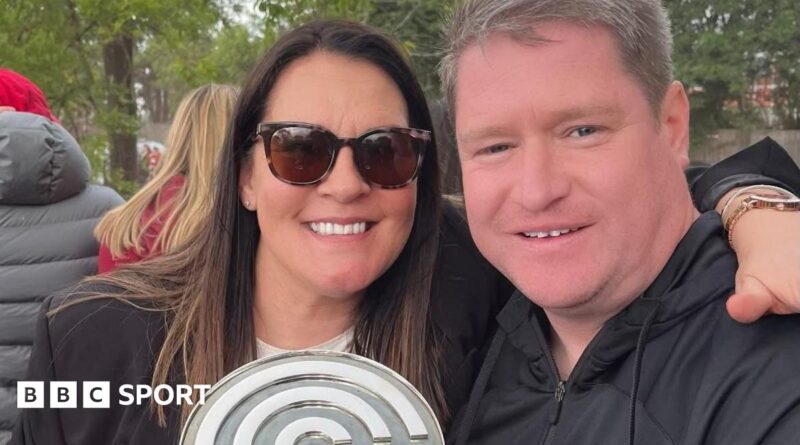 Liverpool Women manager Matt Beard and his wife Debbie smile while celebrating the Reds' Championship title win