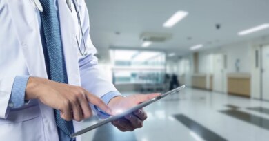 Close-up of a physician's hands holding a tablet, used in a post about healthcare startup Regard