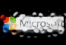 The Microsoft Corp. logo is seen through water droplets.