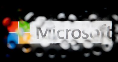 The Microsoft Corp. logo is seen through water droplets.