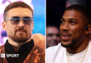 Oleksandr Usyk wearing sunglasses and and orange vest and Anthony Joshua wearing a white t-shirt