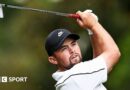 Alex Fitzpatrick watches his ball after playing an iron shot, with the club above his head