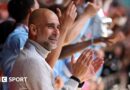 Manager Pep Guardiola applauds as his Manchester City players lift the FA Cup trophy after beating Chelsea in the 2026 final