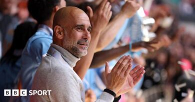 Manager Pep Guardiola applauds as his Manchester City players lift the FA Cup trophy after beating Chelsea in the 2026 final