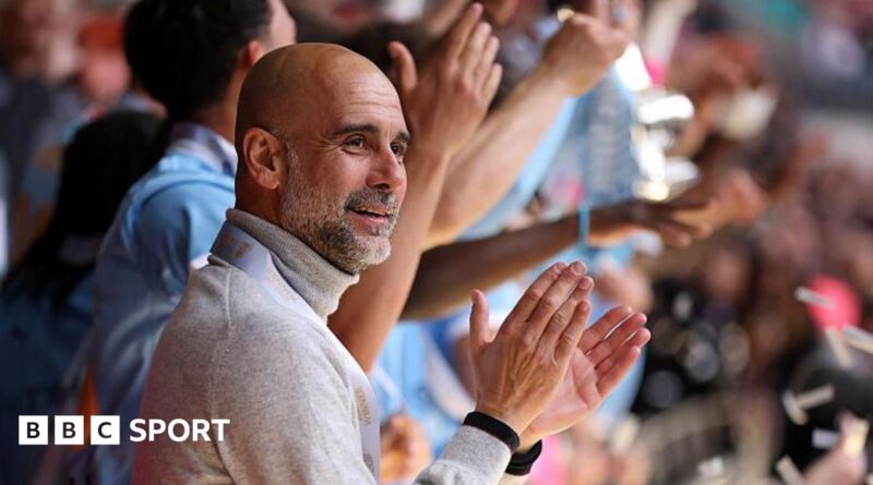 Manager Pep Guardiola applauds as his Manchester City players lift the FA Cup trophy after beating Chelsea in the 2026 final