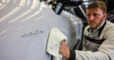 A Porsche employee checks an all-electric Porsche Macan in quality control at the Leipzig plant.