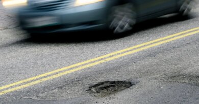 CAPE ELIZABETH, ME - FEBRUARY 22: A car drives past a pothole on Forest Ave. in Portland Tuesday, February 22, 2022. (Shawn Patrick Ouellette/Portland Press Herald via Getty Images)