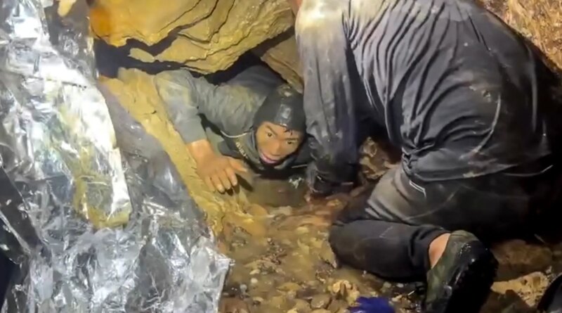 Rescuers race to save two people still trapped in cave in Laos