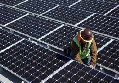 A man inspects solar panels.