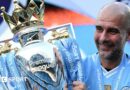Manchester City manager Pep Guardiola holding the Premier League trophy