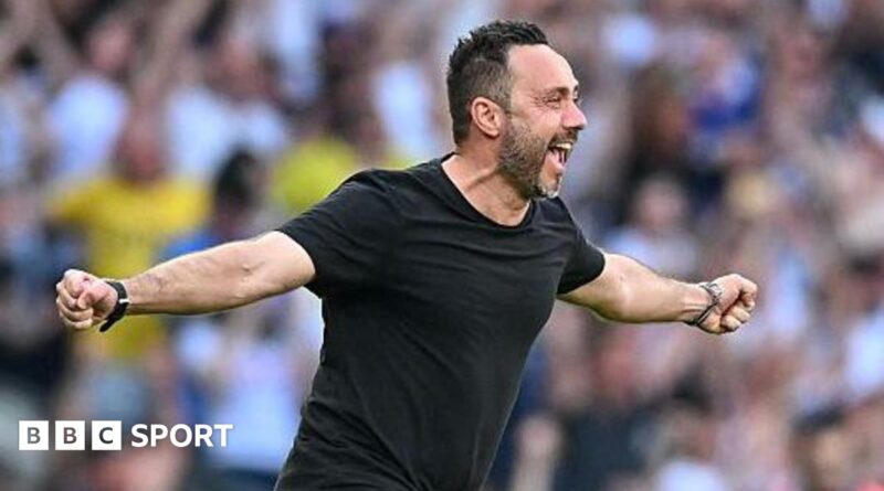 Roberto de Zerbi celebrates with a broad smile and arms outstretched as he runs on to the pitch in a black T-shirt