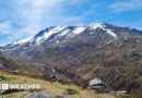 Photograph of a mountain with snow on the peaks along with sunny spells