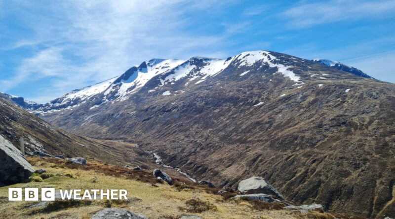 Photograph of a mountain with snow on the peaks along with sunny spells