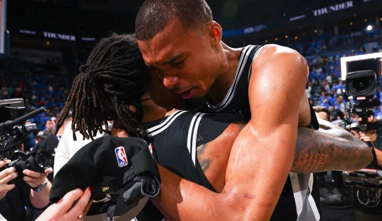 OKLAHOMA CITY, OK - MAY 30: Victor Wembanyama #1 and Devin Vassell #24 of the San Antonio Spurs hug after the game against the Oklahoma City Thunder during Game Seven of the NBA Western Conference Finals on May 30, 2026 at Paycom Center in Oklahoma City, Oklahoma. NOTE TO USER: User expressly acknowledges and agrees that, by downloading and or using this photograph, User is consenting to the terms and conditions of the Getty Images License Agreement. Mandatory Copyright Notice: Copyright 2026 NBAE Zach Beeker/NBAE via Getty Images/AFP (Photo by Zach Beeker / NBAE / Getty Images / Getty Images via AFP)