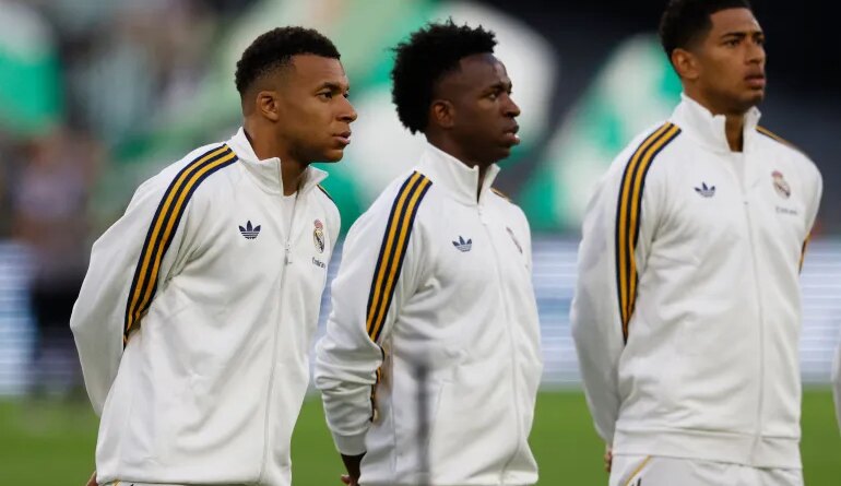 Real Madrid's Kylian Mbappe, Vinicius Junior and Jude Bellingham line up before a La Liga match